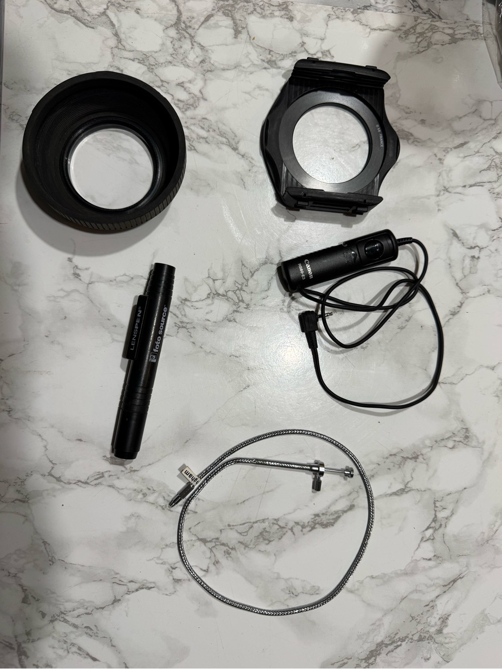 Photography odds and ends- shutter releases cords, lens pen, hood & filter mount